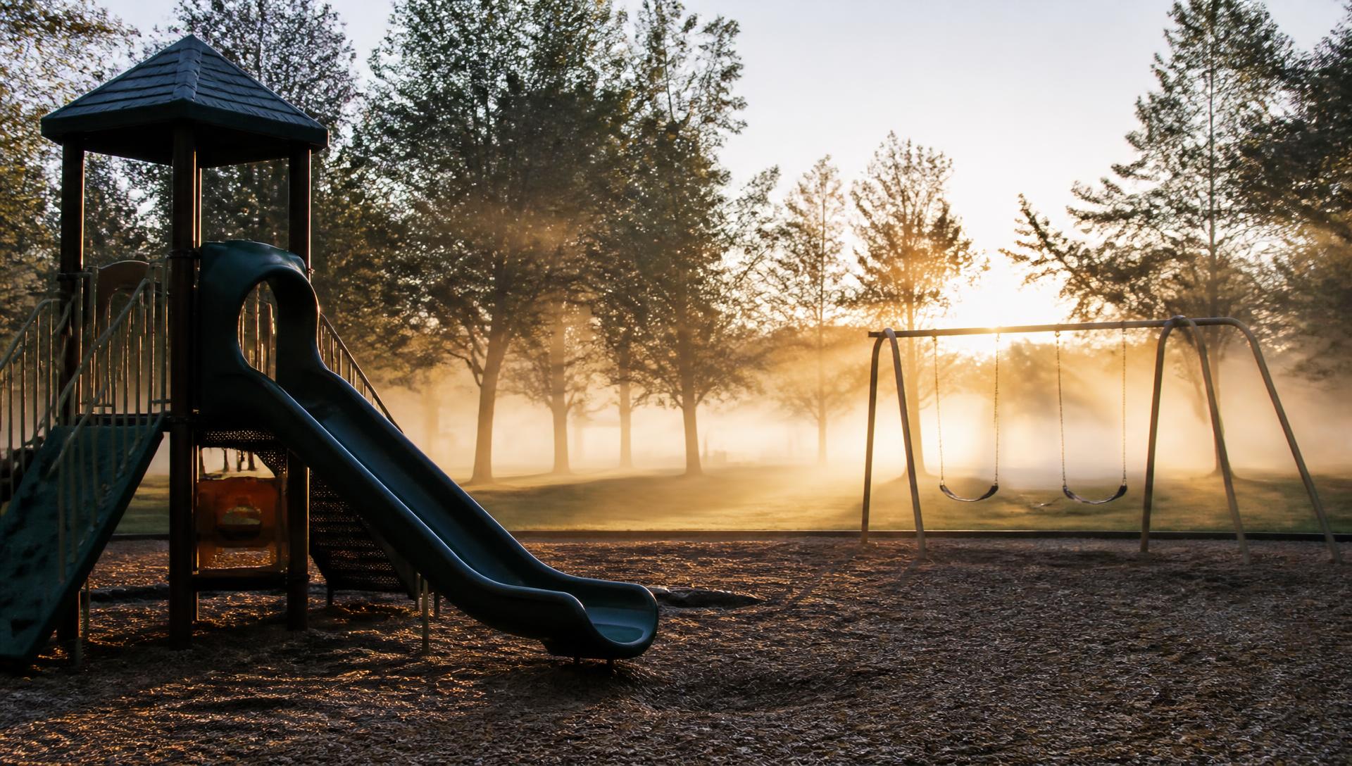 Quiet playground at dawn with warm light